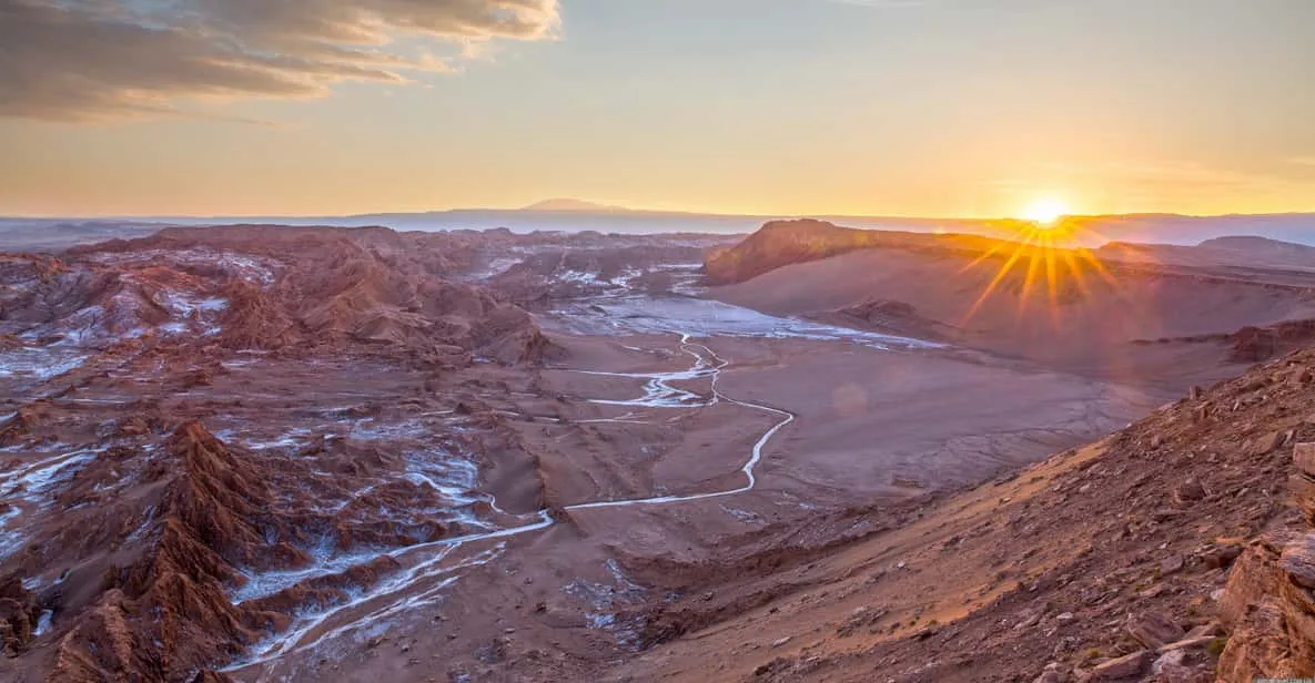 Tourists walking the rim of Moon Valley amphitheatre on a guided Valle de la Luna Atacama Desert tour in Chile
